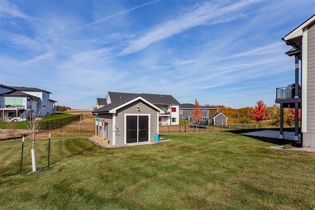 view of yard featuring a patio and an outbuilding