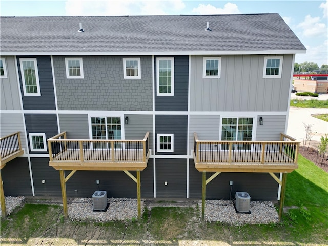 back of property with a wooden deck and cooling unit