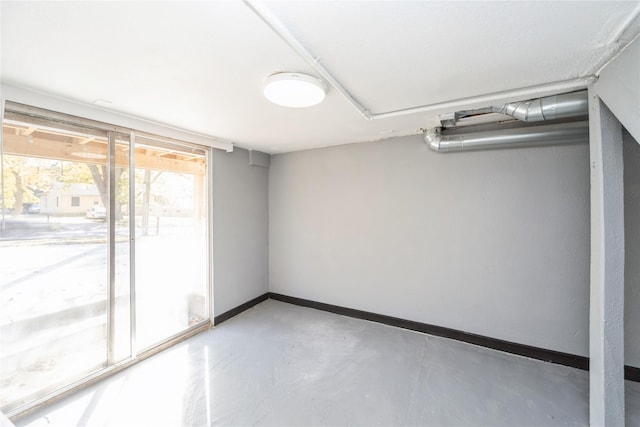 interior space with finished concrete flooring and baseboards