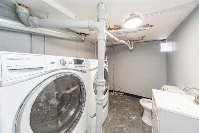 laundry room with washer and dryer, laundry area, and a sink