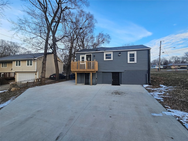 view of front of house featuring a garage and a wooden deck