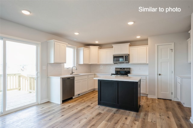 kitchen featuring white cabinets, light hardwood / wood-style floors, and appliances with stainless steel finishes