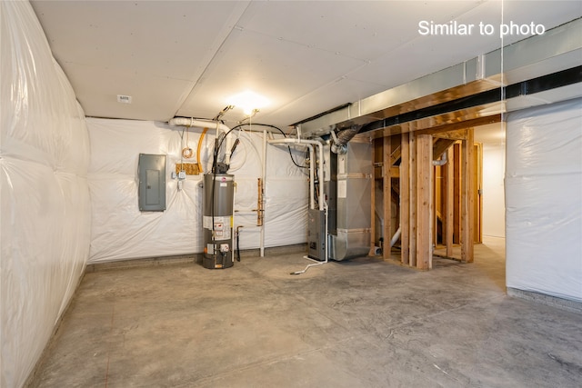 basement with gas water heater, electric panel, and heating unit