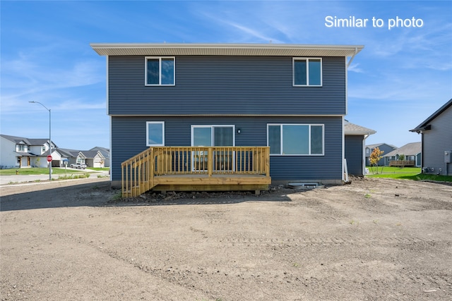 back of property with a wooden deck