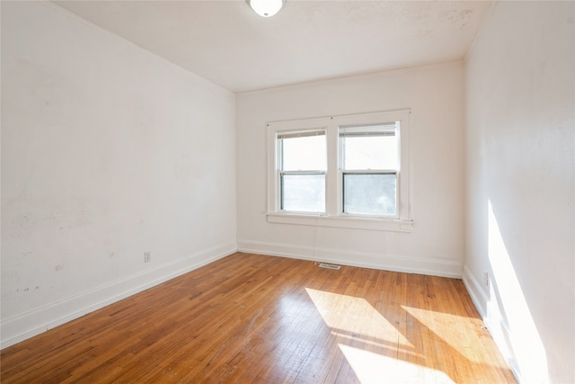 empty room with light hardwood / wood-style flooring