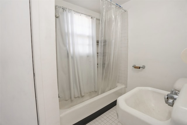 bathroom with tile patterned floors, sink, and shower / bathtub combination with curtain