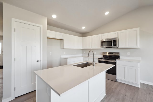 kitchen featuring white cabinetry, appliances with stainless steel finishes, sink, and a kitchen island with sink