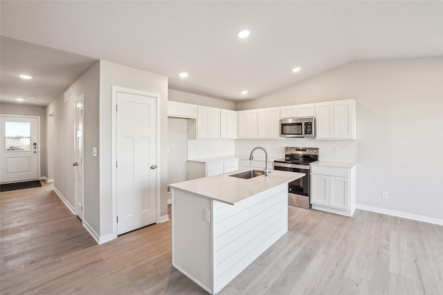 kitchen featuring white cabinetry, a kitchen island with sink, appliances with stainless steel finishes, and a sink