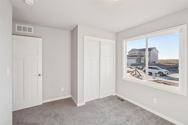 carpeted bedroom featuring a closet