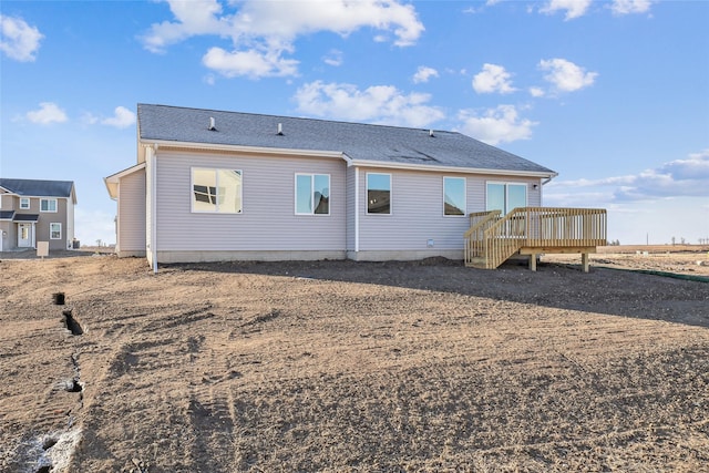 back of property with a wooden deck