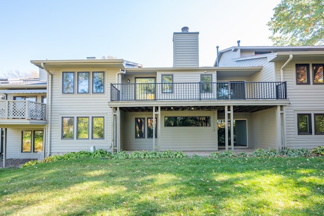 rear view of property with a lawn and a chimney