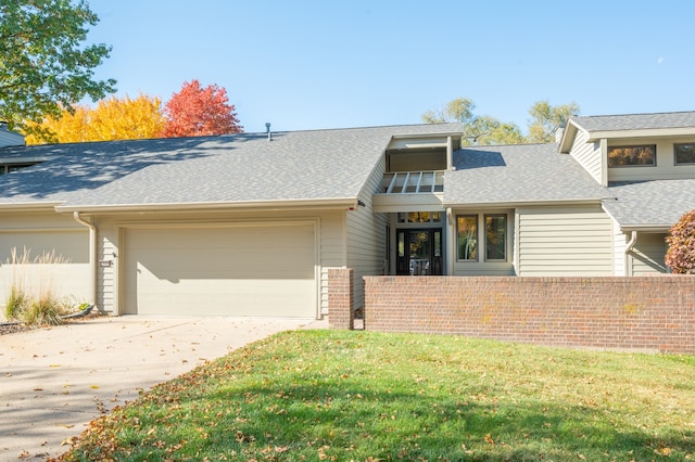 view of front of property with a front yard and a garage