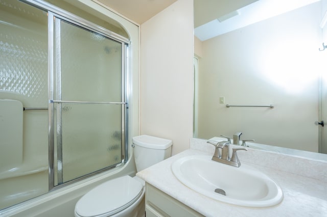 bathroom featuring combined bath / shower with glass door, toilet, and vanity