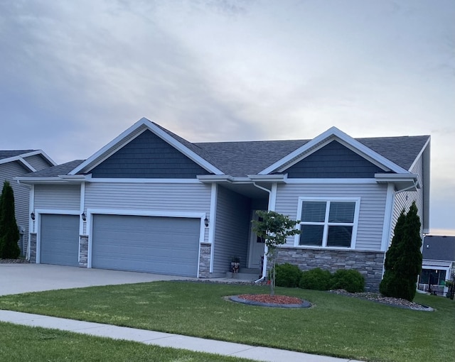 view of front of home with a front lawn and a garage