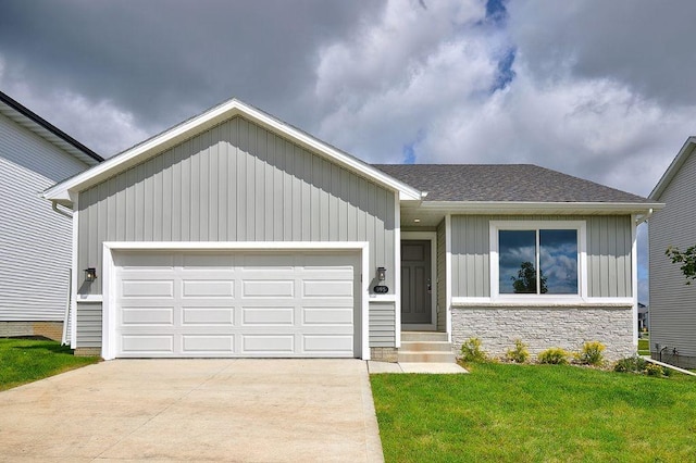 view of front of home with a front yard and a garage