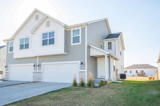 view of front of house featuring central AC, a garage, and a front lawn