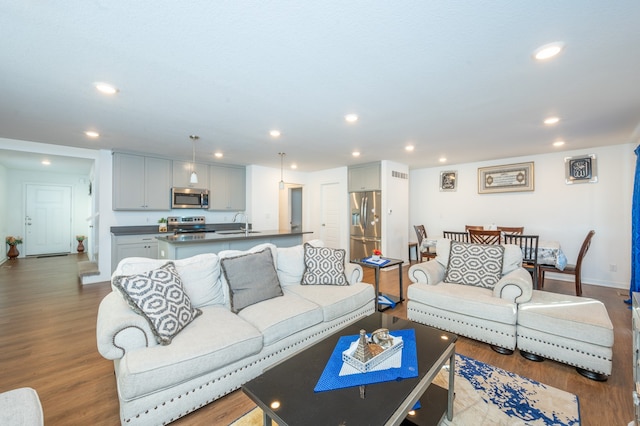 living room featuring light hardwood / wood-style flooring and sink