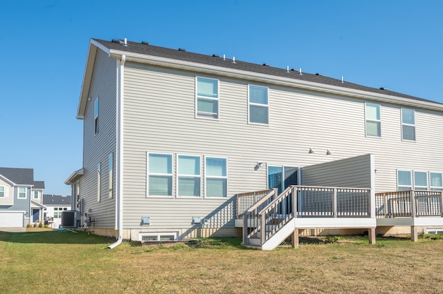rear view of house featuring a yard, a deck, and central AC