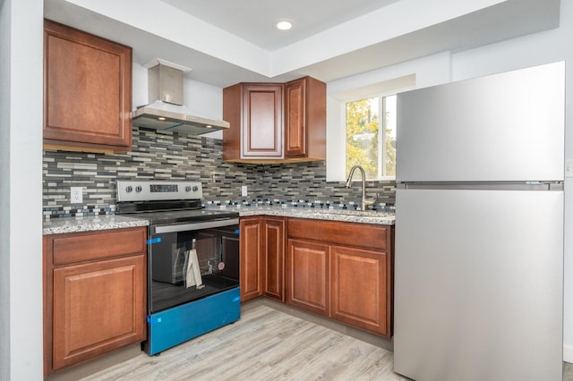 kitchen with sink, light stone counters, refrigerator, electric range, and backsplash