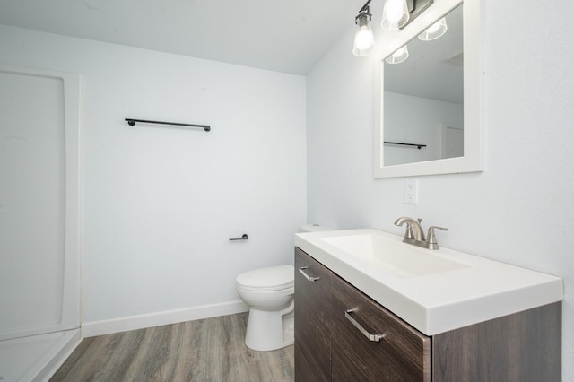 bathroom with vanity, hardwood / wood-style flooring, and toilet