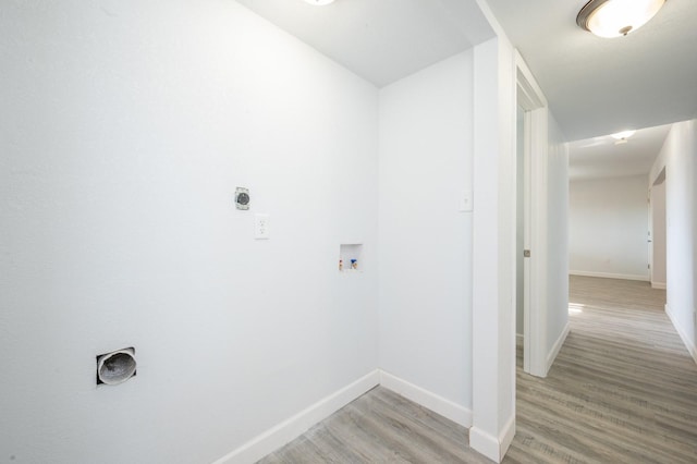 laundry room with hookup for a washing machine and light hardwood / wood-style flooring