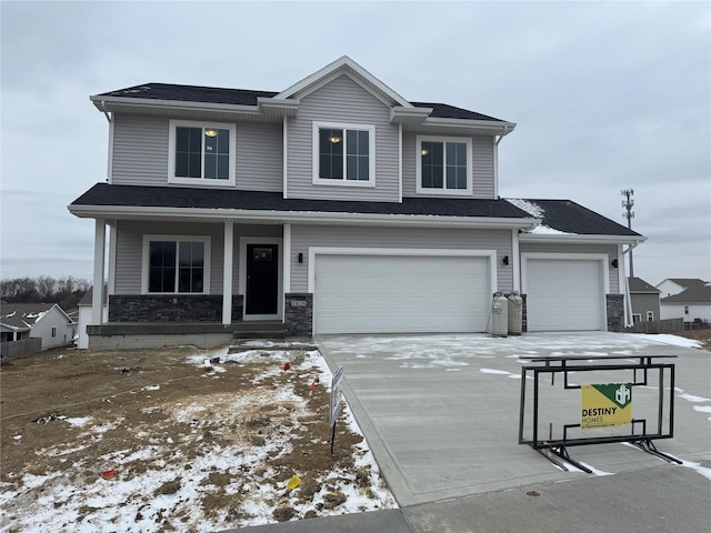 view of front of property featuring a garage and covered porch