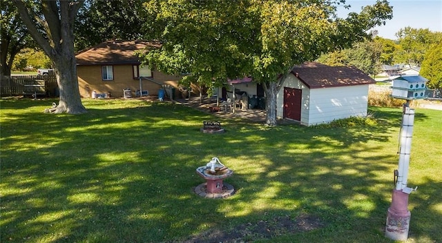 view of yard with a storage unit and a fire pit