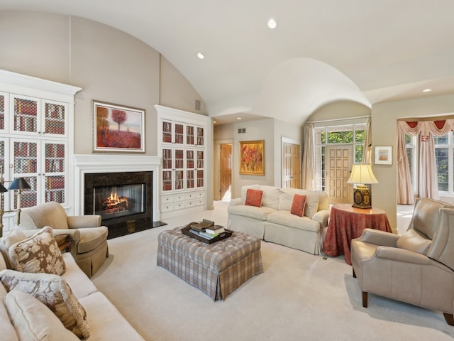 living room with a premium fireplace, vaulted ceiling, and light carpet