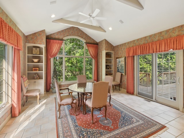 tiled dining room with lofted ceiling, ceiling fan, and a wealth of natural light