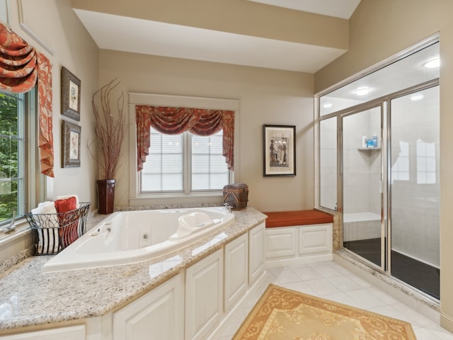 bathroom with independent shower and bath, a wealth of natural light, and tile patterned flooring