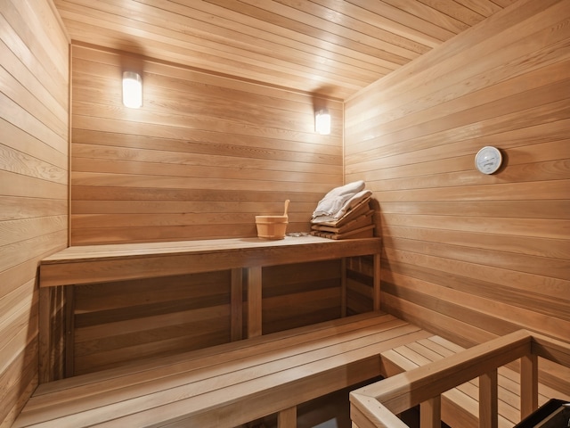 view of sauna with wood ceiling and wood walls