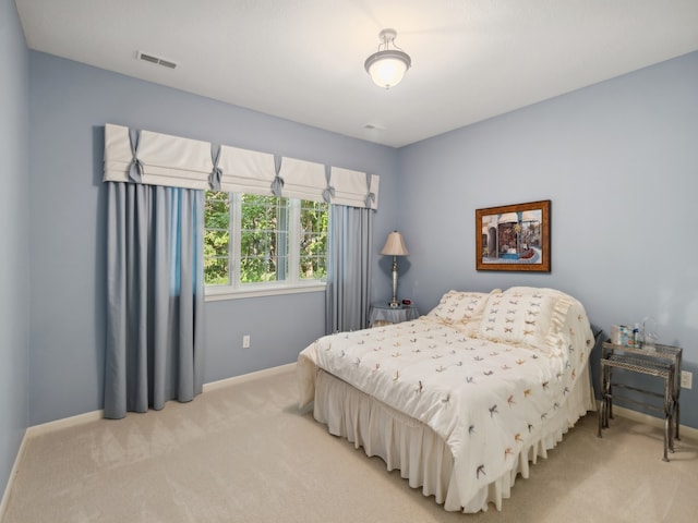 bedroom featuring light carpet