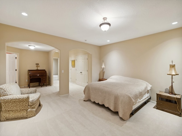 bedroom featuring a closet and light colored carpet