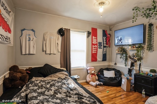 bedroom with hardwood / wood-style floors