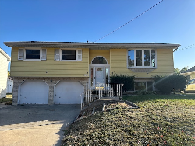 bi-level home with a front lawn and a garage