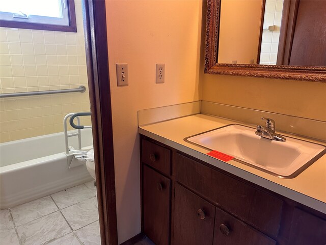 bathroom with vanity, tile patterned floors, toilet, and a bathing tub