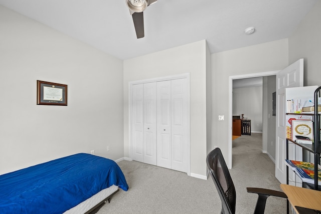 carpeted bedroom featuring a closet and ceiling fan