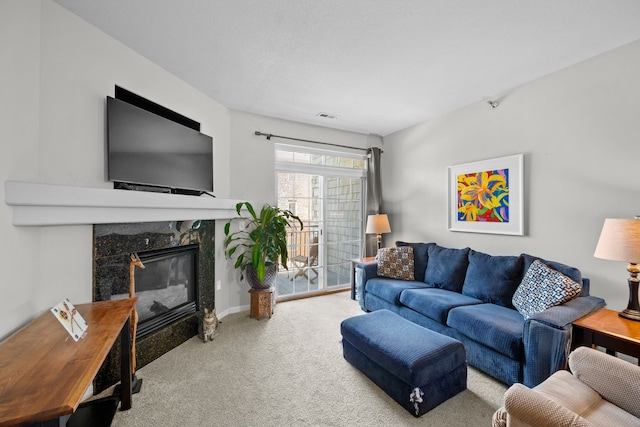 living room with a premium fireplace and carpet floors