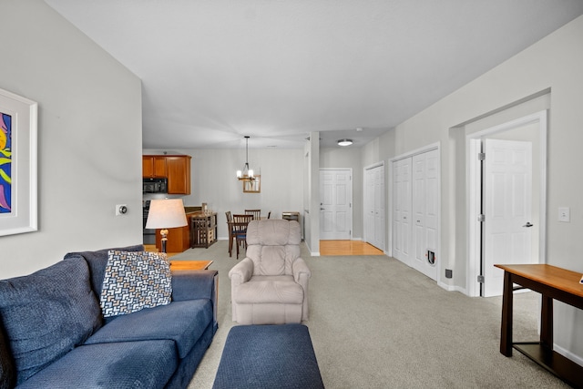 carpeted living room with a notable chandelier