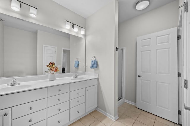 bathroom featuring vanity, tile patterned floors, and walk in shower