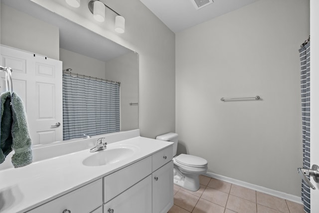 bathroom featuring toilet, curtained shower, vanity, and tile patterned flooring