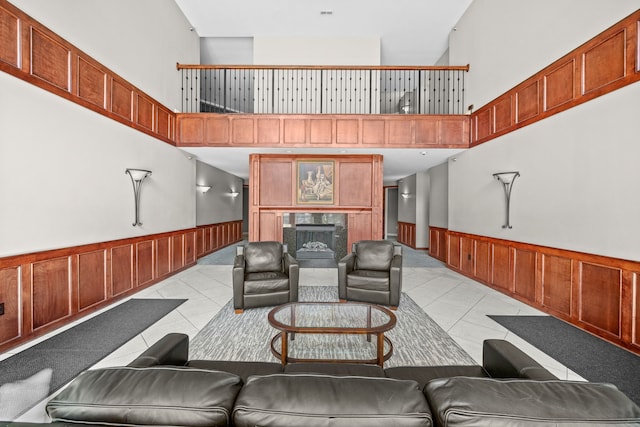 tiled living room with a tiled fireplace and high vaulted ceiling