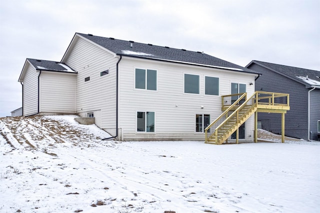 snow covered property featuring a deck