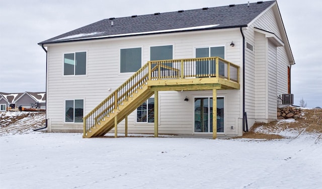 snow covered property with a deck