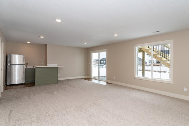 unfurnished living room with carpet