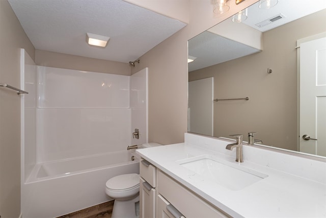 full bathroom featuring toilet, shower / bath combination, wood-type flooring, a textured ceiling, and vanity