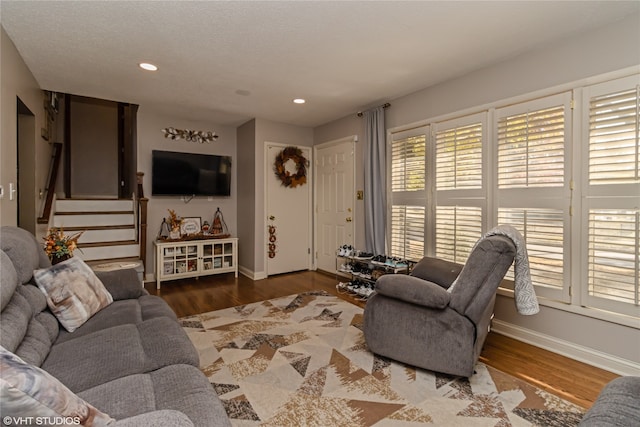 living room featuring hardwood / wood-style floors, a healthy amount of sunlight, and a textured ceiling