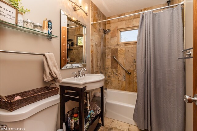 full bathroom featuring toilet, sink, and shower / tub combo