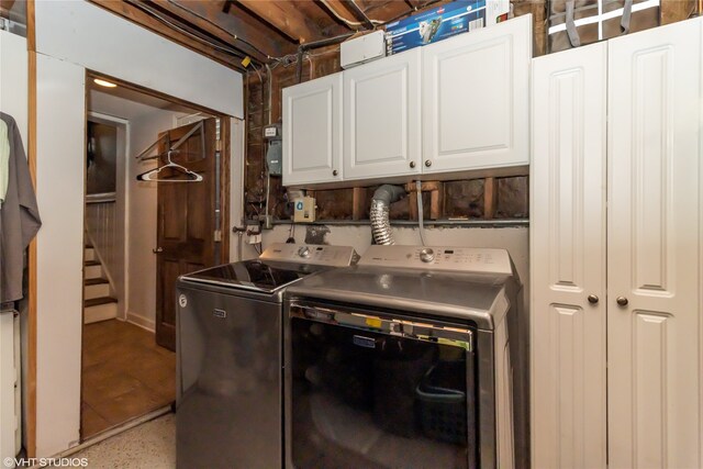 laundry room featuring cabinets and washer and clothes dryer