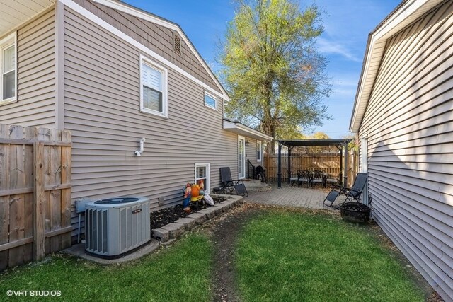 view of home's exterior with a patio, cooling unit, and a yard